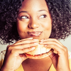 women with a burger representing food service indusry
